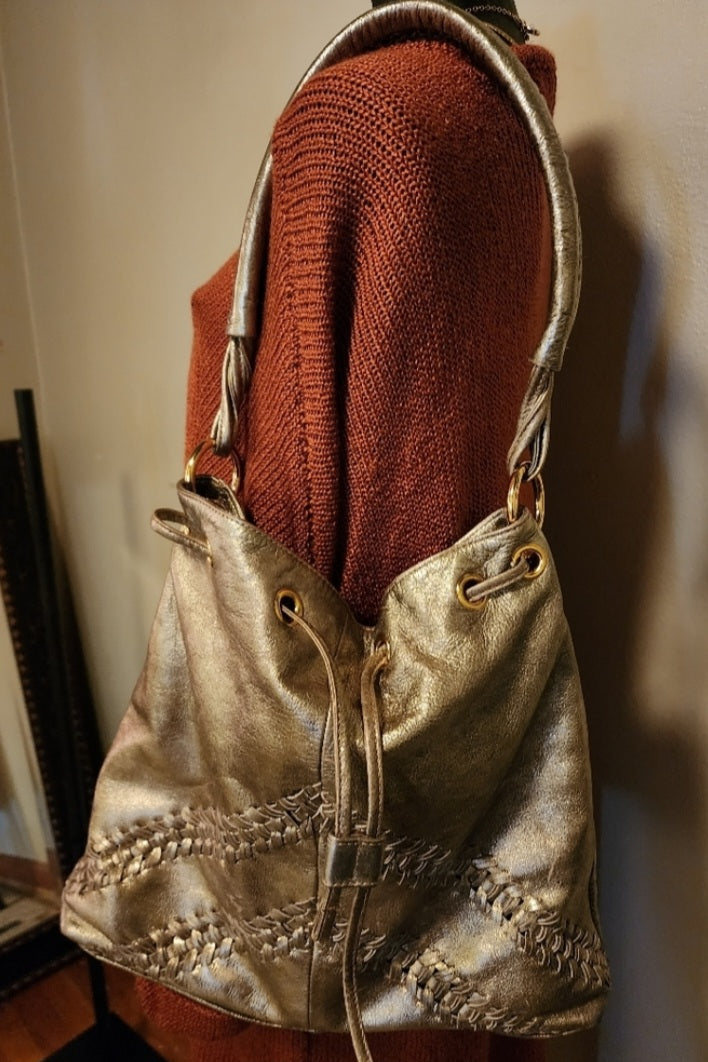 Franco Sarto metallic gold drawstring bag.