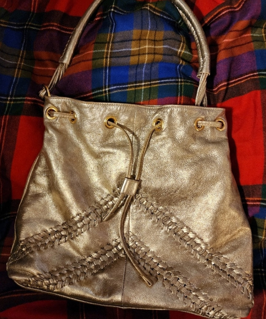 Franco Sarto metallic gold drawstring bag.