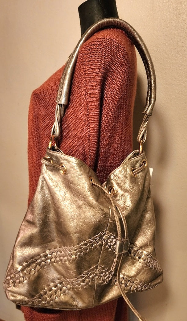 Franco Sarto metallic gold drawstring bag.