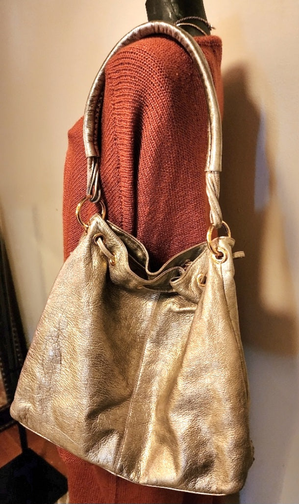 Franco Sarto metallic gold drawstring bag.