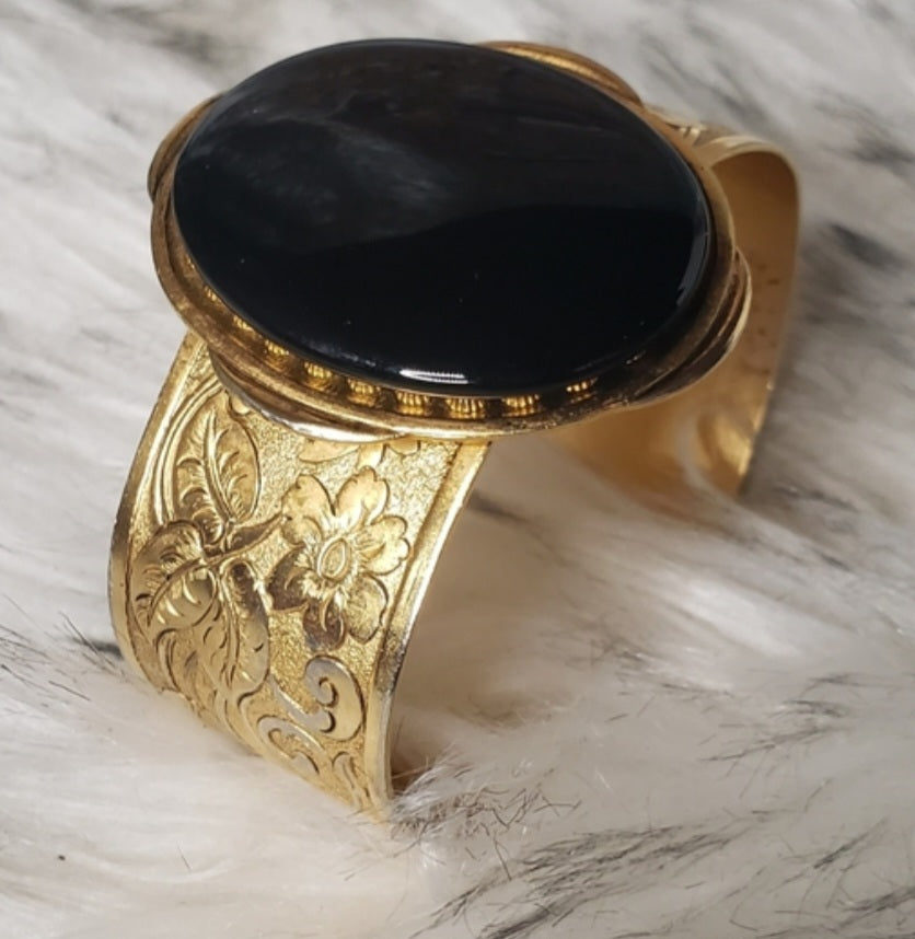 Erica Lyons gold tone onyx cuff bracelet.