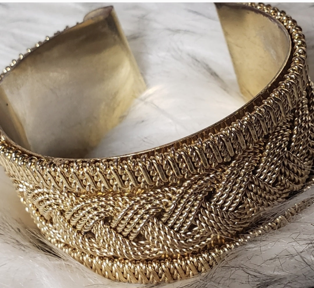 Gold-tone braided design cuff.