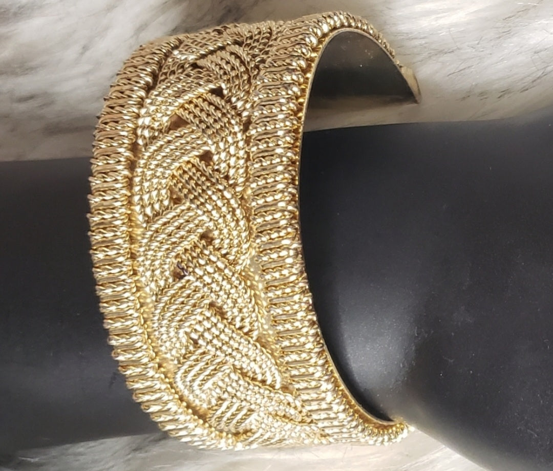 Gold-tone braided design cuff.