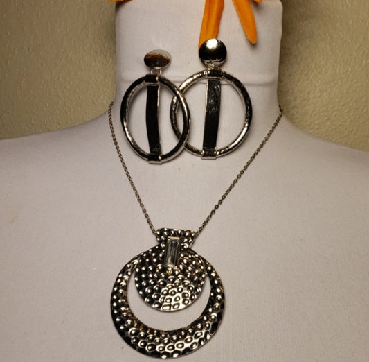 Jessica Simpson silver gong necklace.